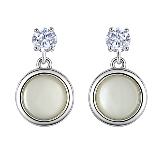 A pair of silver-tone drop earrings featuring a cubic zirconia stud on top and a mother of pearl inlay in a circular design.