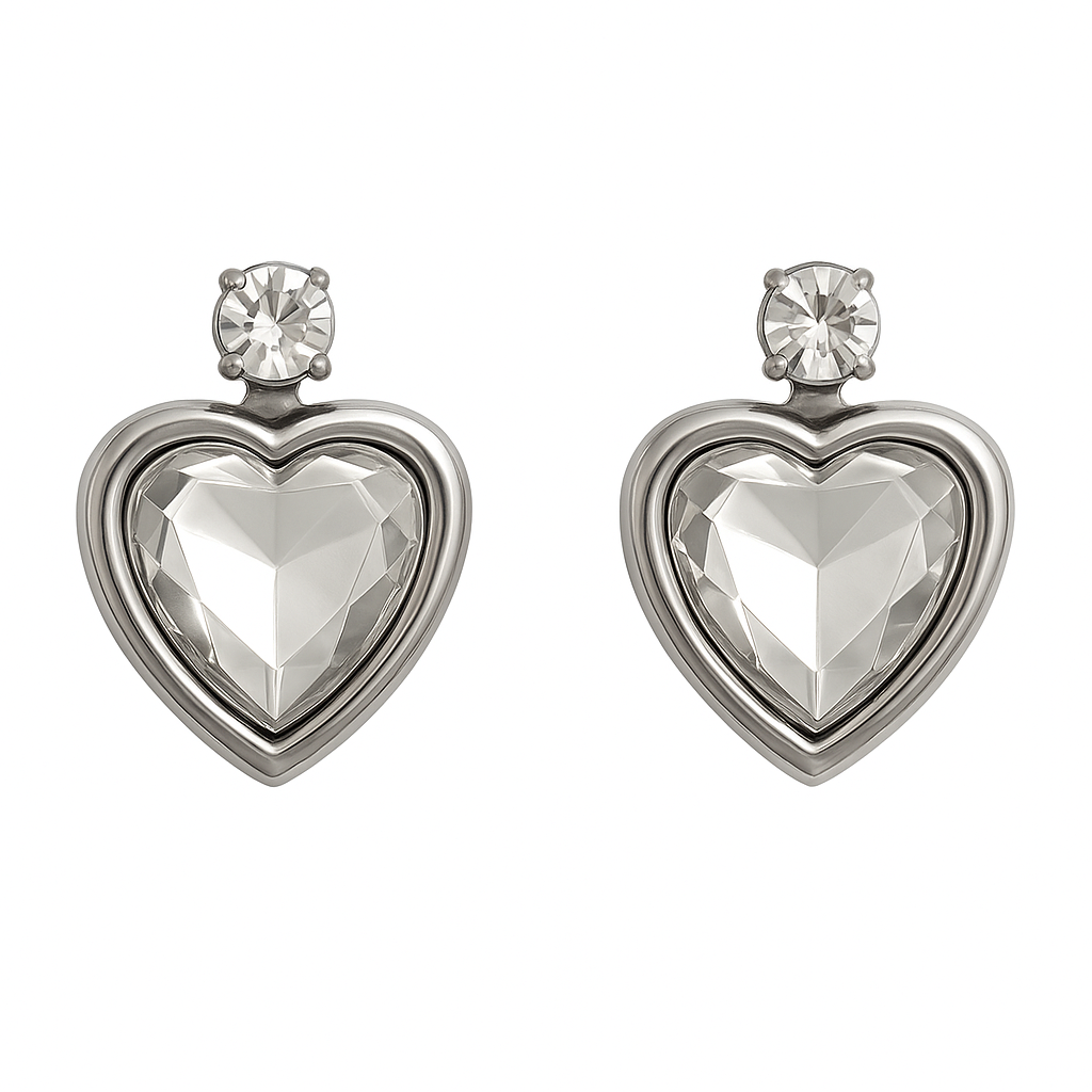 A pair of heart-shaped crystal stud earrings with silver-tone settings.