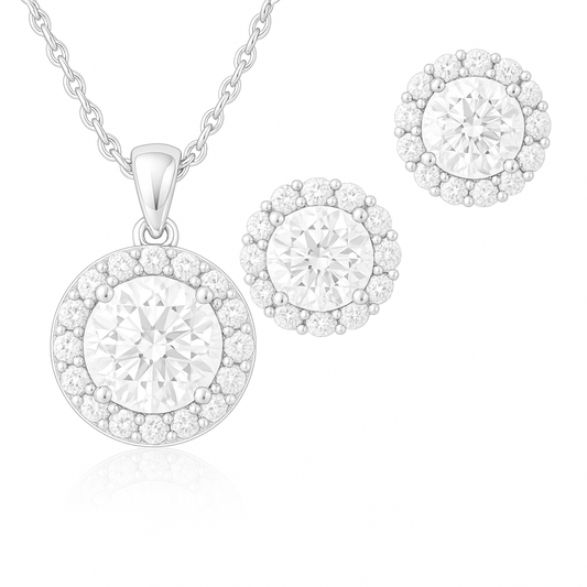 A set of sterling silver jewelry including a pendant necklace and a pair of stud earrings, both featuring a central round-cut cubic zirconia stone surrounded by smaller halo stones.
