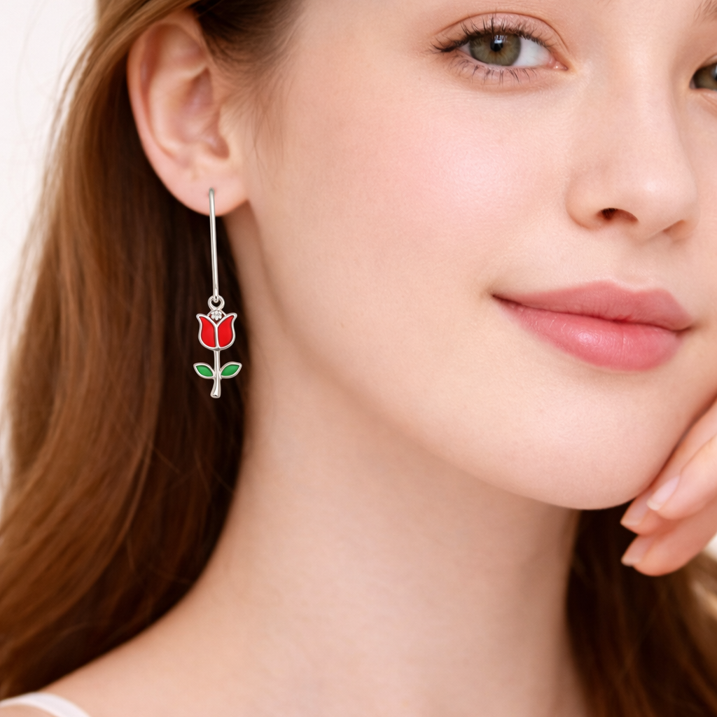 Close-up of a woman wearing a rose-shaped earring with a plain background