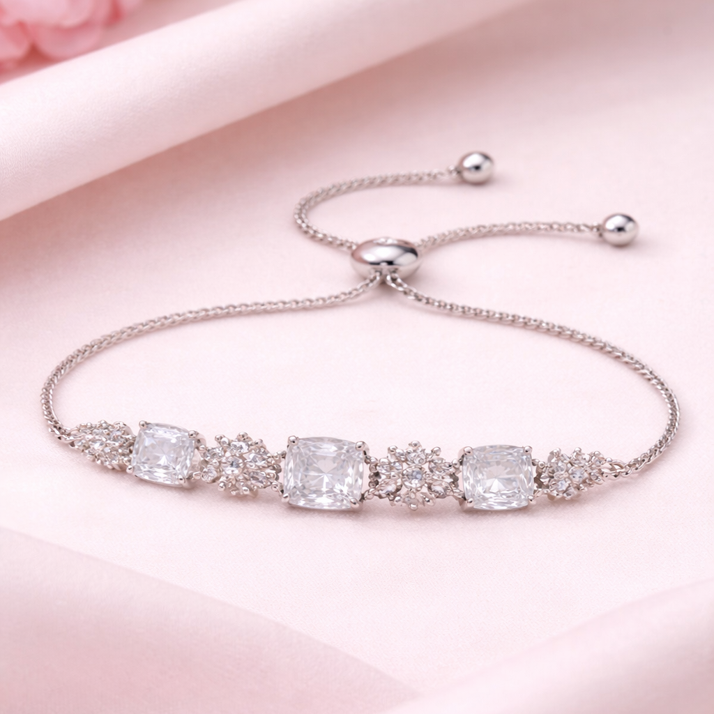 Silver bracelet with clear gemstones on a pink background