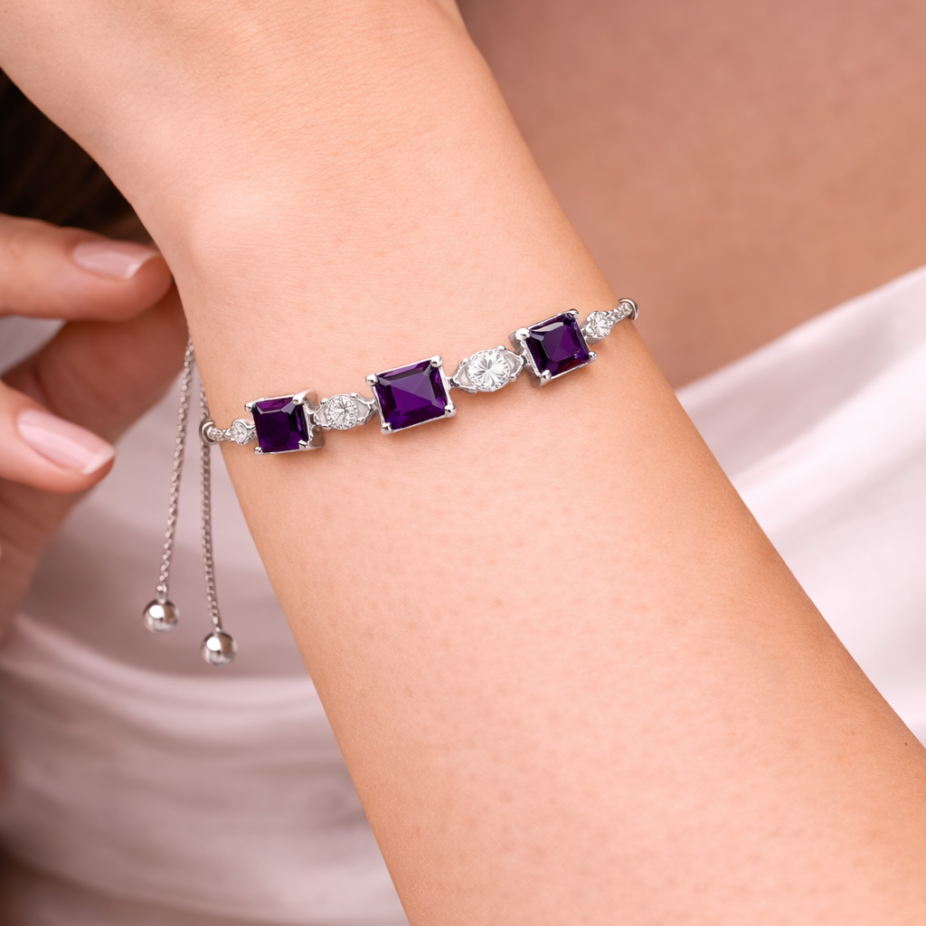 Bracelet with purple gemstones on a person's wrist against a neutral background