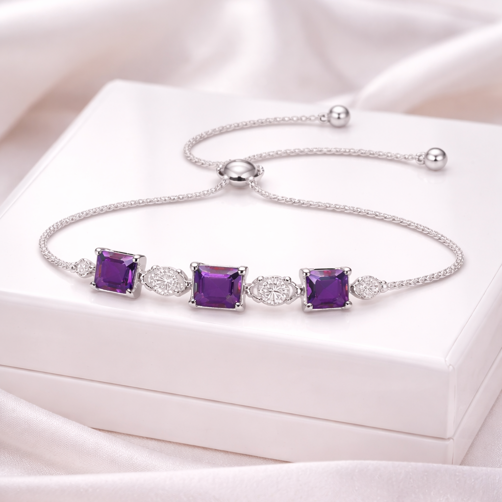 Silver bracelet with purple gemstones on a pink satin surface